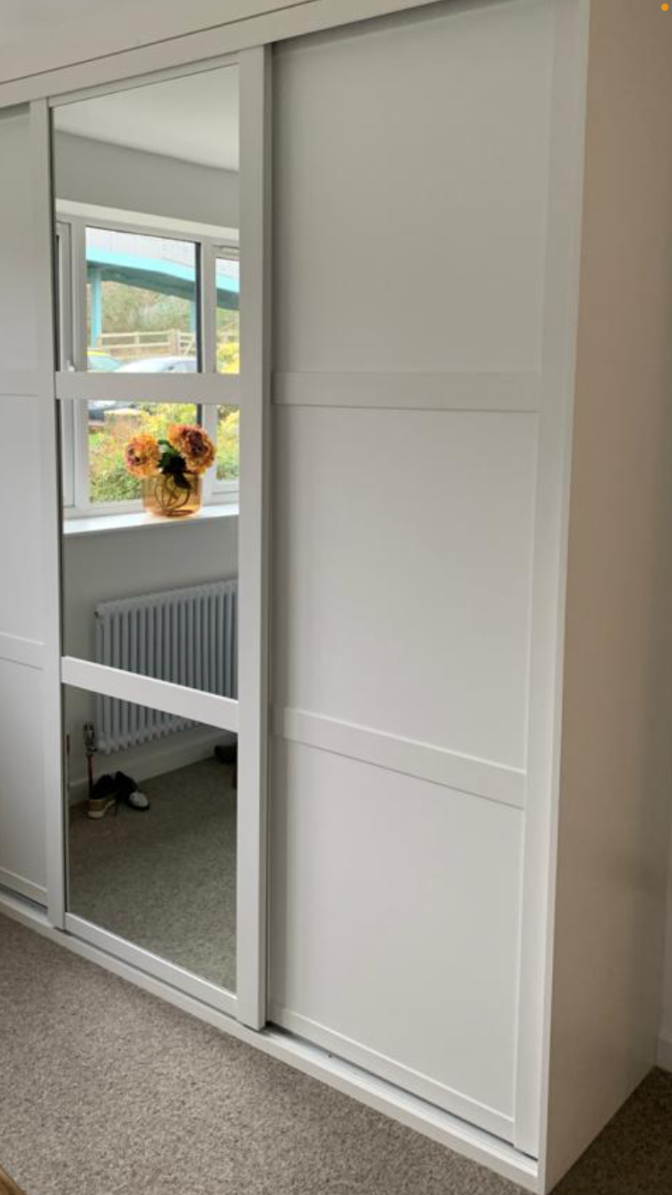 Define Sliding Wardrobe System with White Frames, 3 x three- part horizontal doors, 2 x White Board Doors & 1 x Silver Mirror door