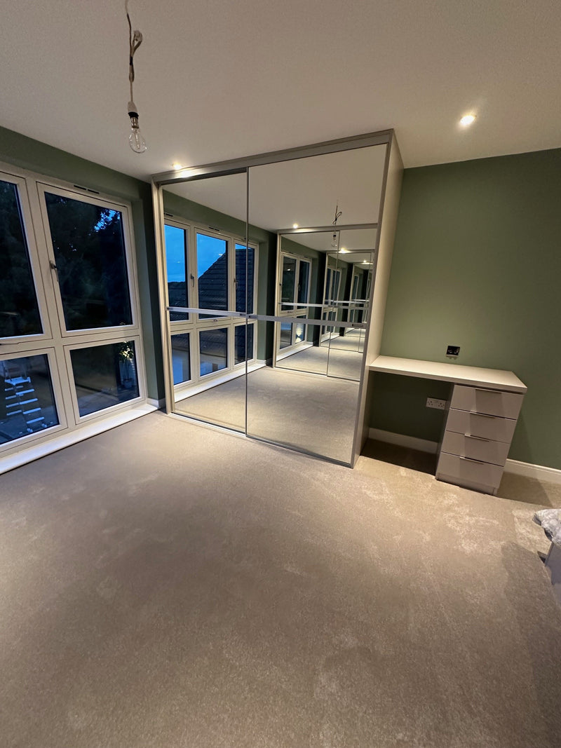 Stream Sliding Wardrobe kit. With Silver Mirror Panels. The desk was also made with our Axis Interior Drawers and Materials.